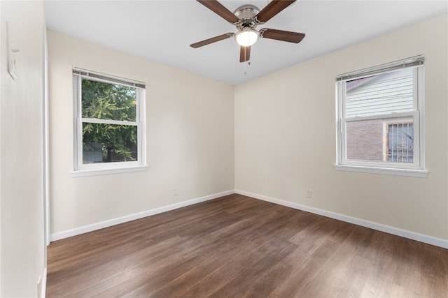 spare room with dark hardwood / wood-style floors and ceiling fan