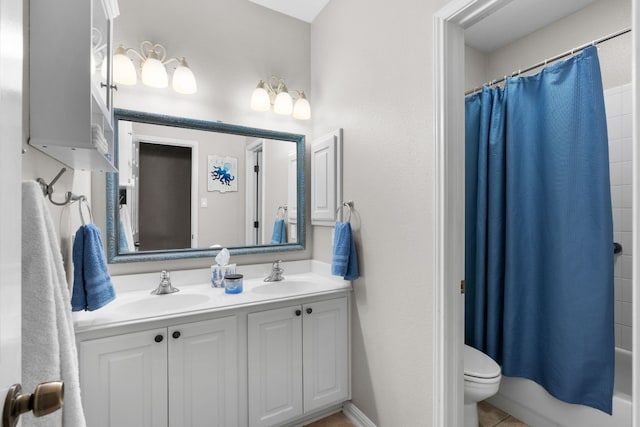 full bathroom featuring tile patterned floors, vanity, toilet, and shower / bath combo with shower curtain