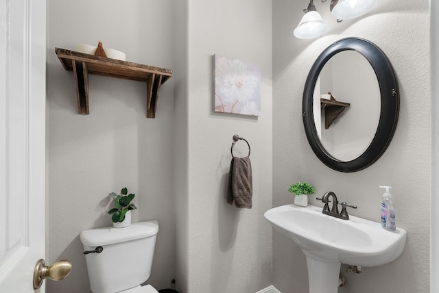 bathroom featuring sink and toilet