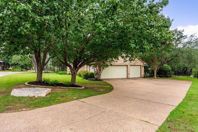 view of property hidden behind natural elements with a front lawn