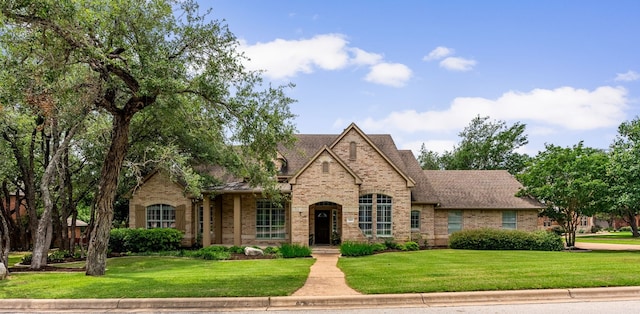 3109 Wild Rock Cv, Austin, TX 78732 - view of front facade with a shingled roof, a front lawn, and brick siding