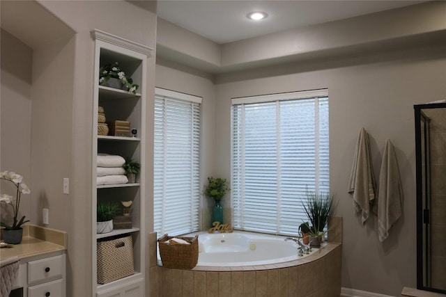 bathroom featuring tiled tub