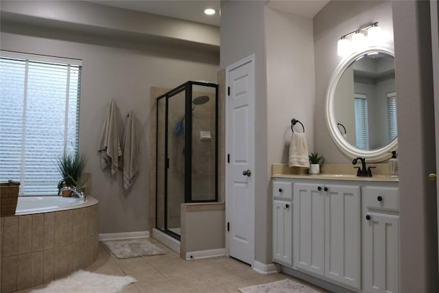 bathroom with tile patterned floors, independent shower and bath, and vanity