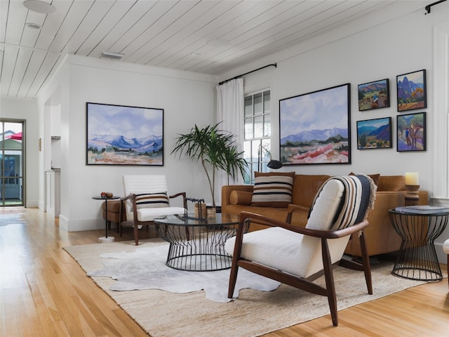 sitting room featuring wood ceiling, light hardwood / wood-style floors, and ornamental molding