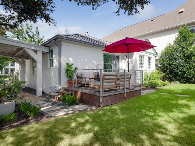 back of house featuring a yard and a wooden deck