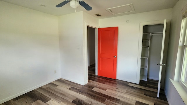 unfurnished bedroom with a closet, ceiling fan, and hardwood / wood-style flooring