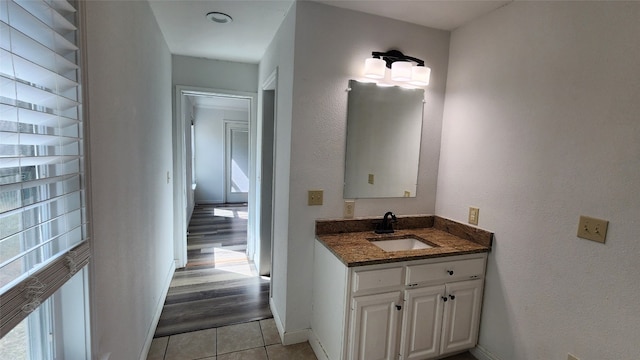 bathroom with vanity, hardwood / wood-style floors, and a healthy amount of sunlight