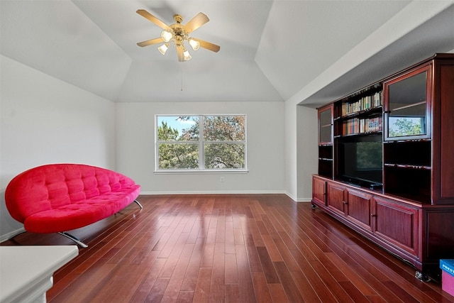 living area featuring ceiling fan, lofted ceiling, and dark hardwood / wood-style flooring