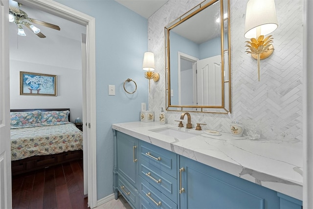 bathroom with ceiling fan, vanity, backsplash, and hardwood / wood-style floors