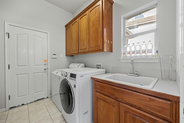 9228 Limoncillo Dr, Austin, TX 78750 - laundry room with cabinet space, washing machine and clothes dryer, and light tile patterned flooring