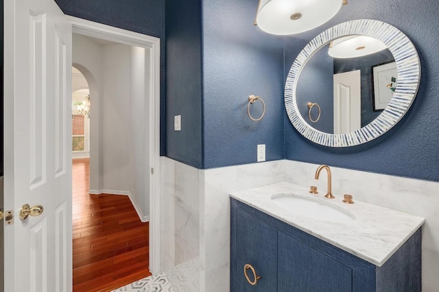 9228 Limoncillo Dr, Austin, TX 78750 - bathroom with wood finished floors, vanity, and a textured wall