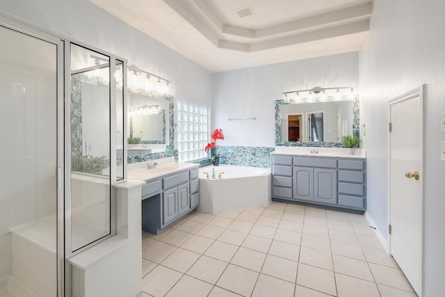 9228 Limoncillo Dr, Austin, TX 78750 - bathroom with a bath, two vanities, tile patterned flooring, and a stall shower