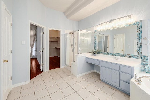 9228 Limoncillo Dr, Austin, TX 78750 - bathroom featuring a stall shower, a spacious closet, vanity, tile patterned floors, and a bath