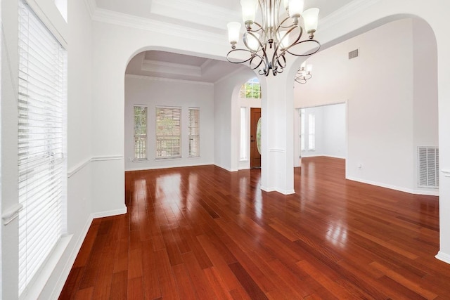 9228 Limoncillo Dr, Austin, TX 78750 - unfurnished dining area with arched walkways, wood finished floors, a chandelier, and crown molding