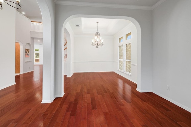 9228 Limoncillo Dr, Austin, TX 78750 - unfurnished dining area featuring a chandelier, wood finished floors, arched walkways, ornamental molding, and a raised ceiling
