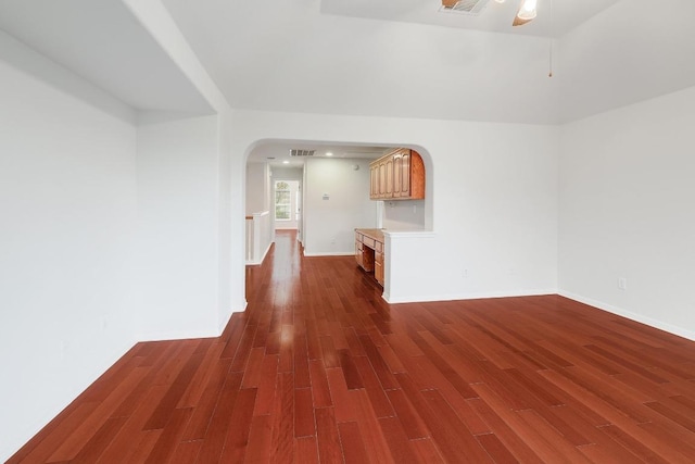 9228 Limoncillo Dr, Austin, TX 78750 - unfurnished living room with wood finished floors and arched walkways
