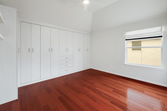 9228 Limoncillo Dr, Austin, TX 78750 - unfurnished bedroom featuring dark wood-style flooring, a closet, and vaulted ceiling