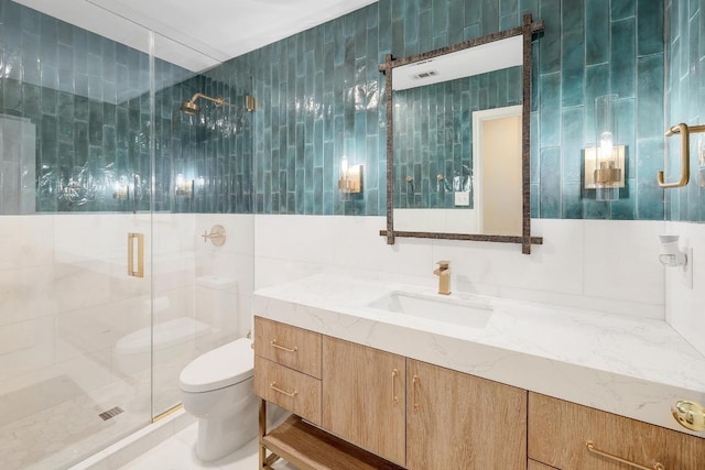 9228 Limoncillo Dr, Austin, TX 78750 - bathroom with vanity, a shower stall, and tile walls
