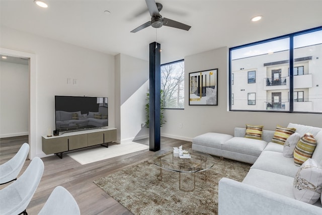 living room featuring ceiling fan and light wood-type flooring