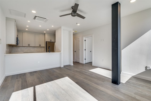 unfurnished living room featuring ceiling fan and light hardwood / wood-style floors