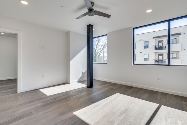 spare room with ceiling fan and dark hardwood / wood-style flooring