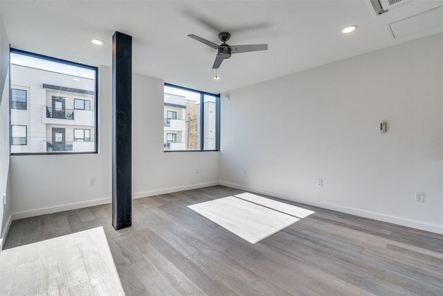 empty room with light hardwood / wood-style floors and ceiling fan