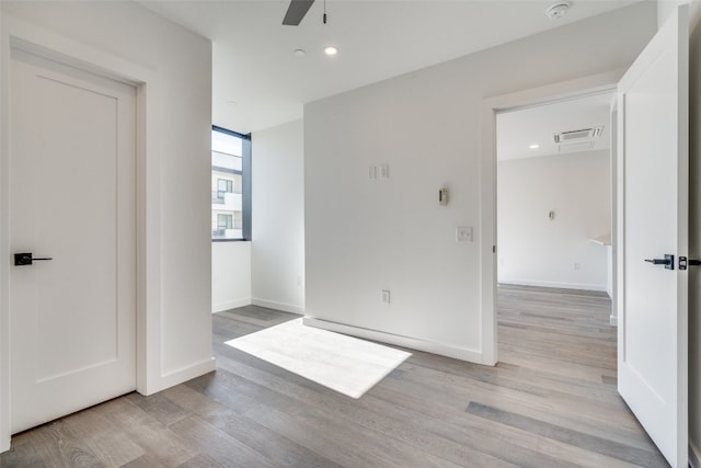 spare room featuring ceiling fan and light hardwood / wood-style flooring