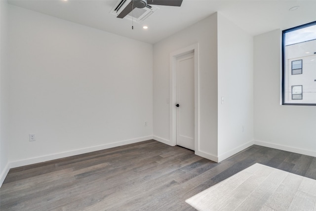 empty room featuring ceiling fan and dark hardwood / wood-style floors