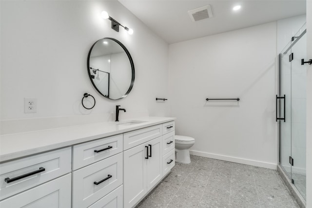 bathroom with walk in shower, vanity, and toilet