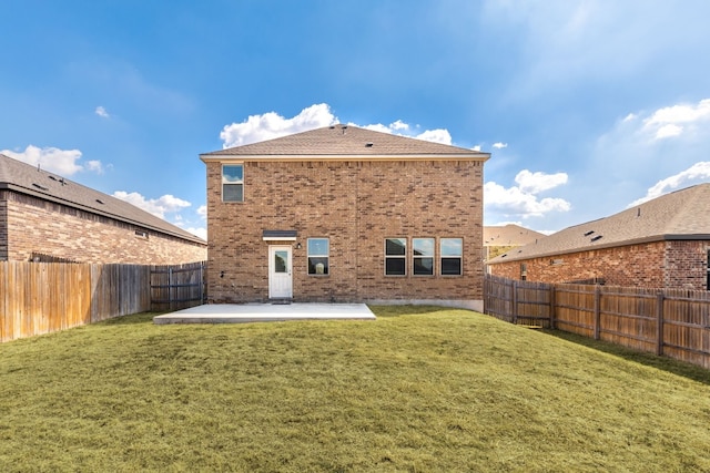 back of house with a lawn and a patio