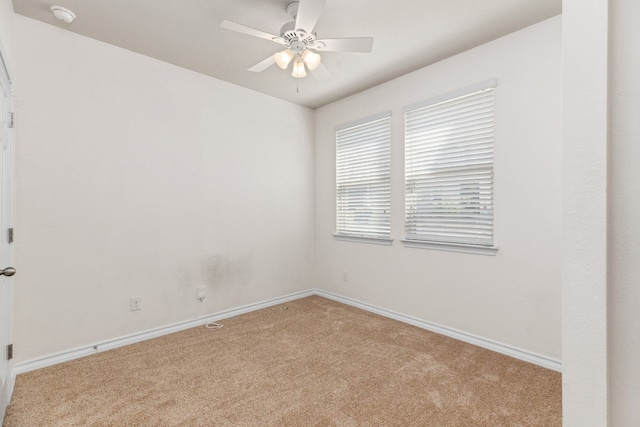 unfurnished room featuring ceiling fan and light colored carpet