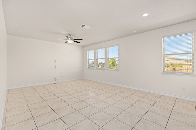 unfurnished room with ceiling fan, plenty of natural light, and light tile patterned flooring