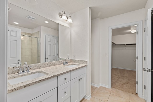 bathroom featuring vanity, tile patterned flooring, and an enclosed shower