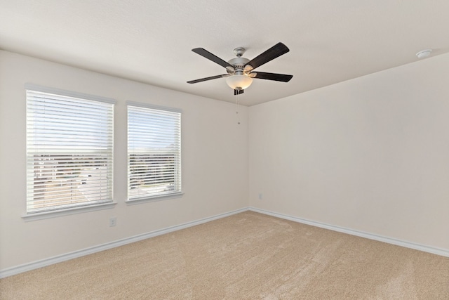 unfurnished room featuring light carpet and ceiling fan