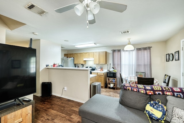 living room with ceiling fan and dark hardwood / wood-style floors