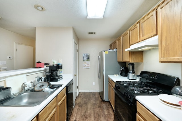 kitchen featuring a textured ceiling, black appliances, dark hardwood / wood-style floors, and sink