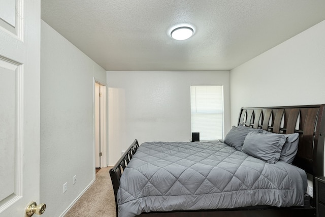 carpeted bedroom featuring a textured ceiling