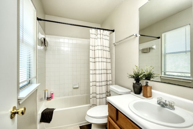 full bathroom featuring vanity, toilet, shower / bath combo with shower curtain, and plenty of natural light