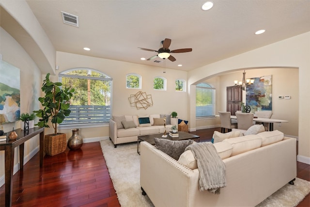 living room featuring hardwood / wood-style floors and ceiling fan with notable chandelier