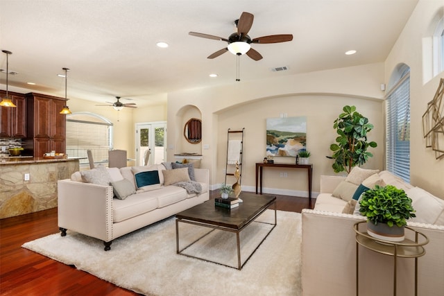 living room with dark hardwood / wood-style floors, ceiling fan, and french doors