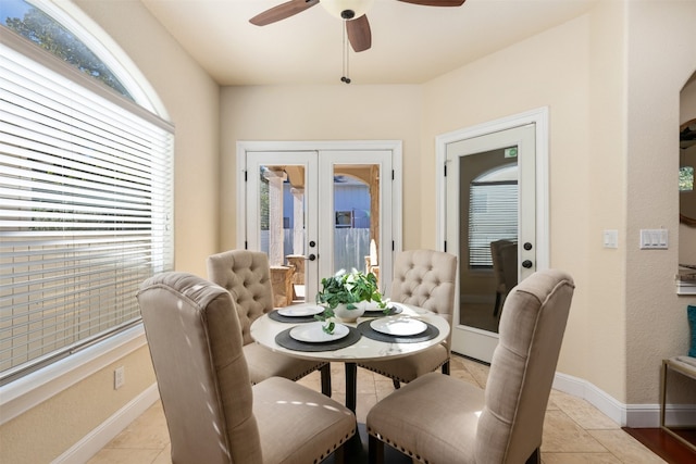 tiled dining area with ceiling fan, french doors, and plenty of natural light