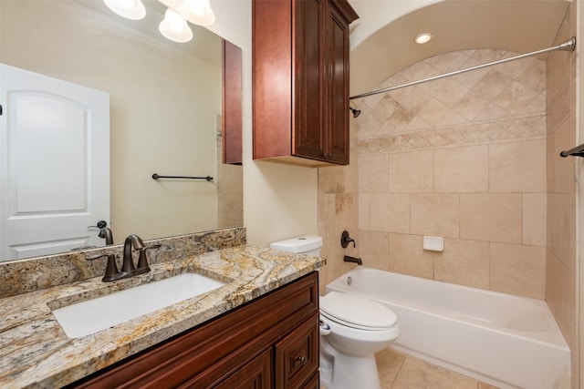 full bathroom with tile patterned flooring, tiled shower / bath combo, toilet, and vanity