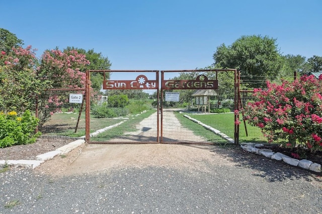 view of gate with a yard