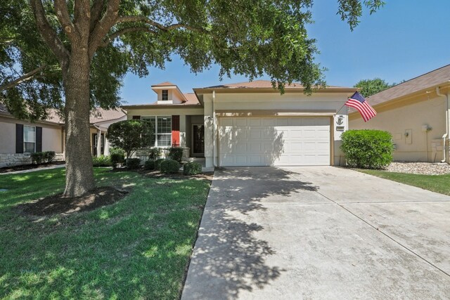 view of front of property with a garage and a front yard