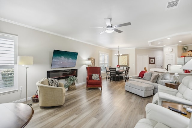 living room featuring crown molding, light hardwood / wood-style flooring, and ceiling fan with notable chandelier