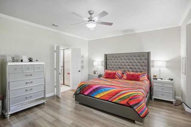 bedroom with visible vents, crown molding, baseboards, and wood finished floors