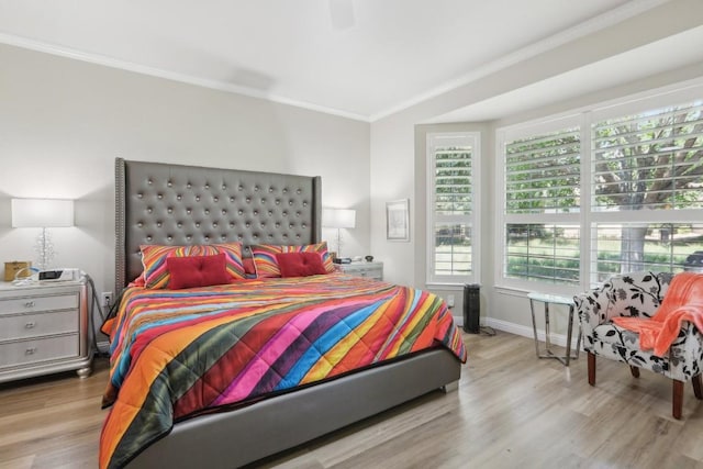 bedroom featuring ornamental molding, wood finished floors, a ceiling fan, and baseboards