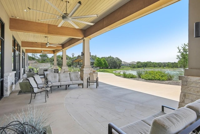 view of patio / terrace with a water view, ceiling fan, and an outdoor hangout area