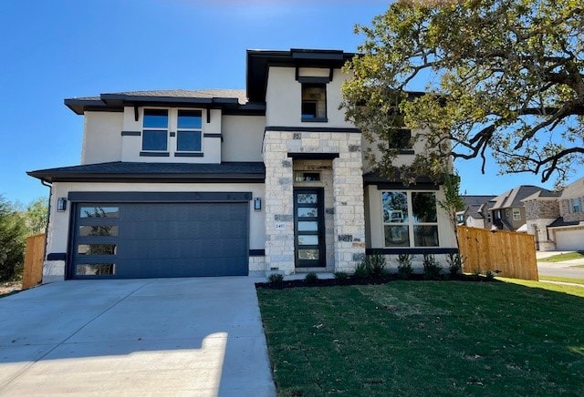 view of front of house featuring a front yard and a garage