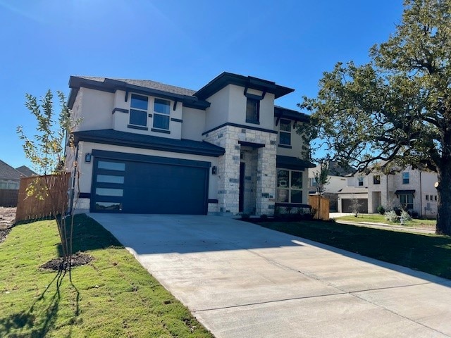 view of front of property featuring a garage and a front yard